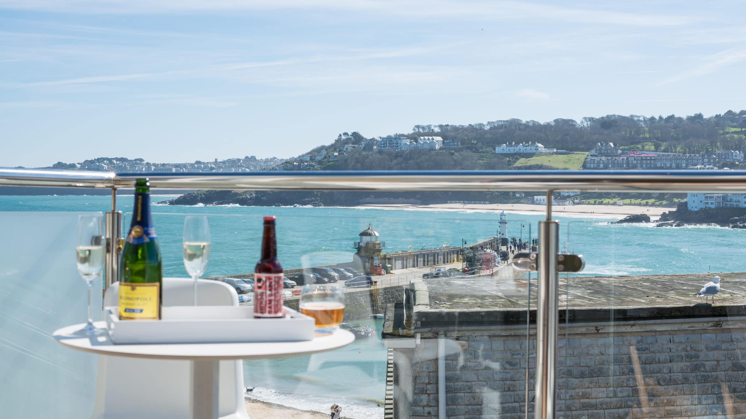 Balcony overlooking St Ives Harbour with prosecco and beer