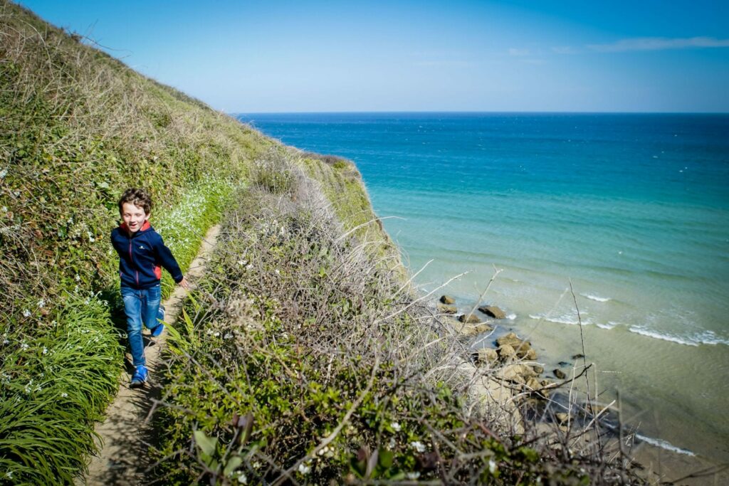 Boy running on south west coast path in Cornwall