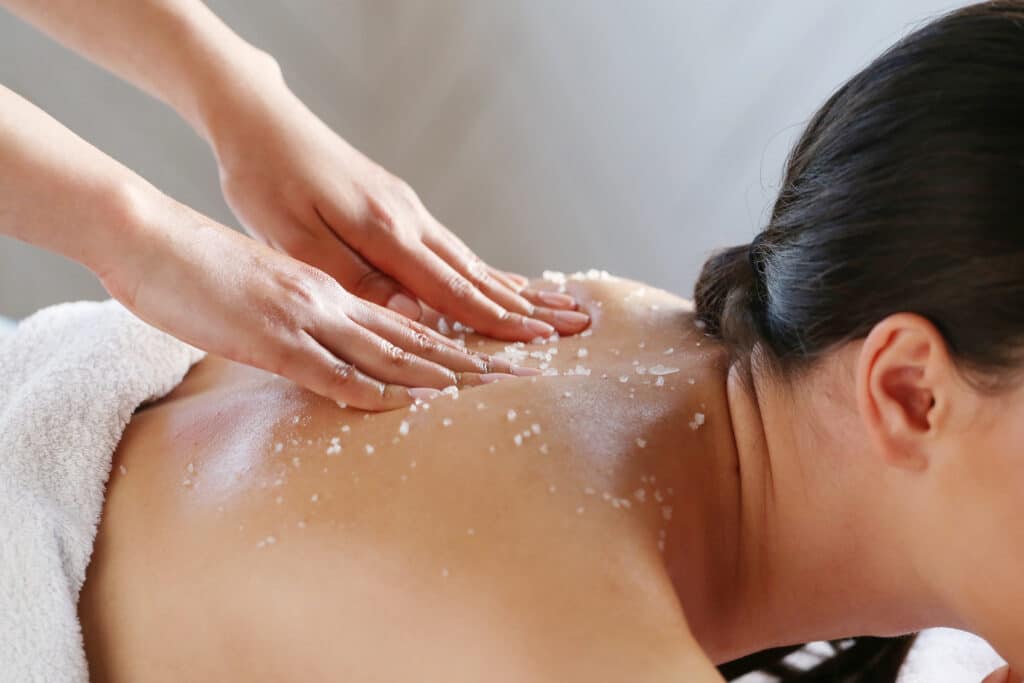 Girl enjoying a salt scrub treatment at a spa